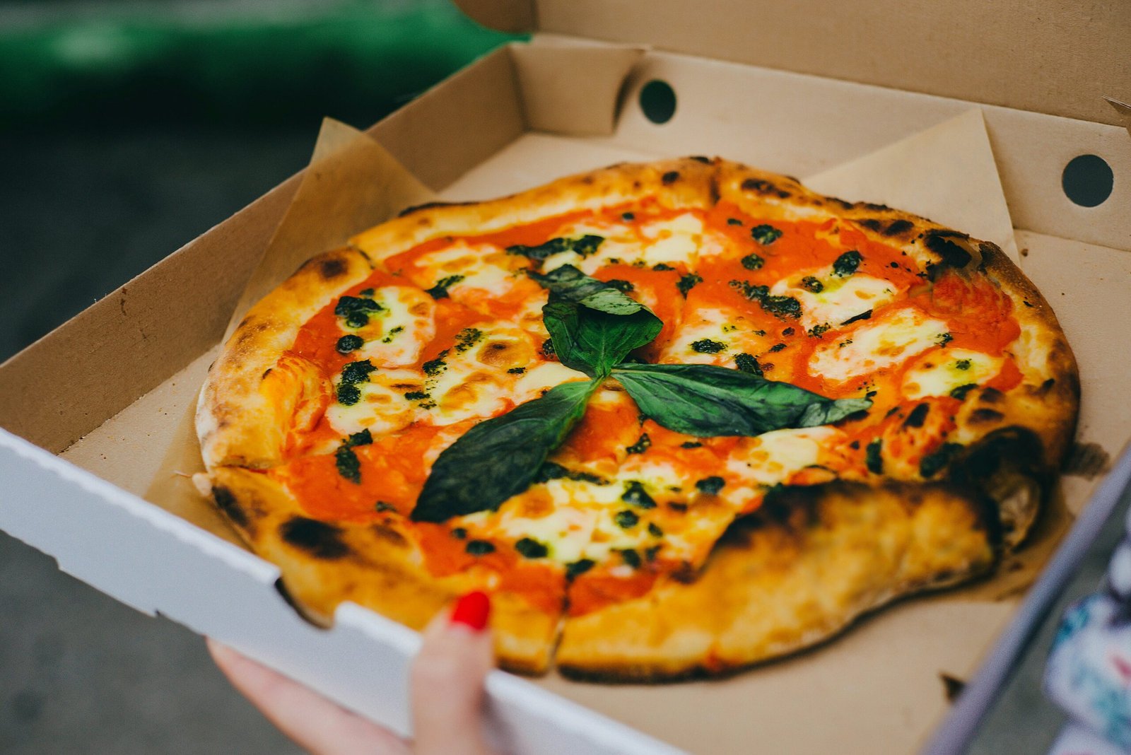 Bezglutenowa pizza margherita z mozzarellą, sosem pomidorowym i świeżą bazylią w pudełku na wynos