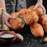 zdjęcie pierogów pieczonych trzymanych w rękach nad stołem